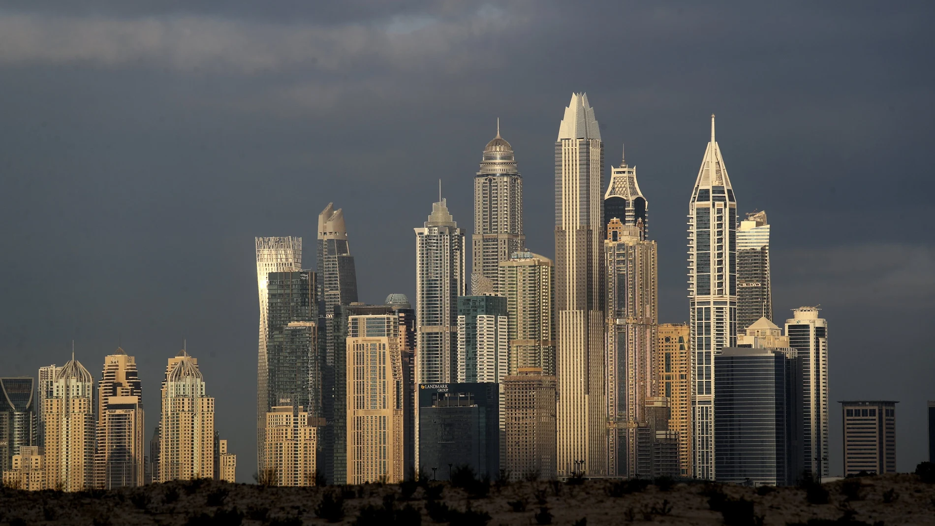 The sunrise reflects on city skylines at the Marina and Jumeirah Lake Towers districts in Dubai, United Arab Emirates, Saturday, Feb. 27, 2021. (AP Photo/Kamran Jebreili)