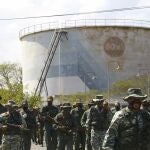 Soldiers patrol near an oil refinery during a military drill to mark the eighth death anniversary of President Hugo Chavez, in Puerto La Cruz, Venezuela, Friday, March 5, 2021. (AP Photo/Juan Carlos Hernandez Soria)