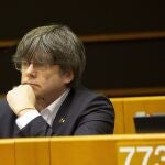 Catalonia's former regional president and MEP Carles Puigdemont listens during a session in the Plenary chamber of the European Parliament in Brussels, Tuesday, March 10, 2020. EU lawmakers were due to take part in a drastically shortened European parliamentary session in Brussels amid concern about the spread of coronavirus. EU leaders were also due to hold a videoconference Tuesday to coordinate efforts across the 27-nation bloc to slow the disease down. (AP Photo/Virginia Mayo)