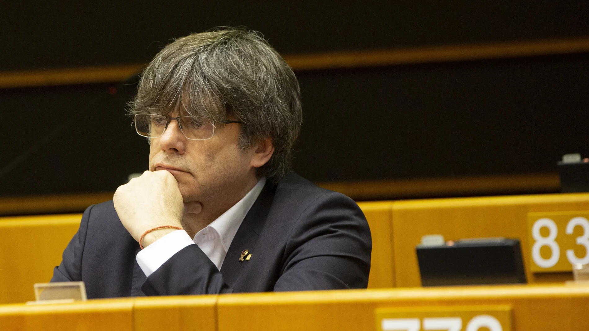 Catalonia's former regional president and MEP Carles Puigdemont listens during a session in the Plenary chamber of the European Parliament in Brussels, Tuesday, March 10, 2020. EU lawmakers were due to take part in a drastically shortened European parliamentary session in Brussels amid concern about the spread of coronavirus. EU leaders were also due to hold a videoconference Tuesday to coordinate efforts across the 27-nation bloc to slow the disease down. (AP Photo/Virginia Mayo)