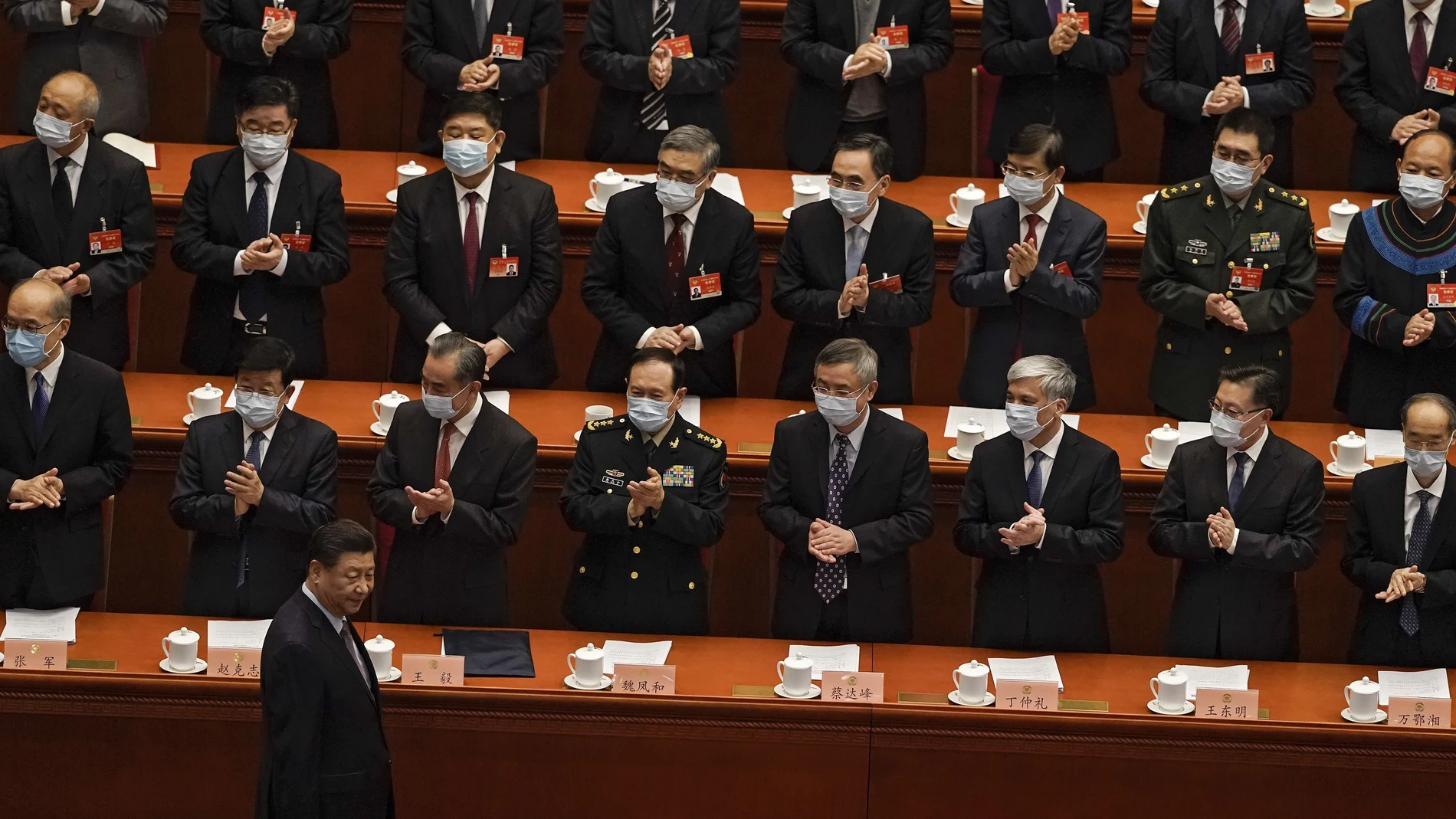 FILE - In this March 4, 2021, file photo, delegates wearing face masks to help curb the spread of the coronavirus applaud as Chinese President Xi Jinping arrives for the opening session of Chinese People's Political Consultative Conference (CPPCC) at the Great Hall of the People in Beijing. The catchword â€œrejuvenationâ€ has been tucked into the major speeches at China's biggest political event of the year, the meeting of its 3,000-member legislature. (AP Photo/Andy Wong, File)