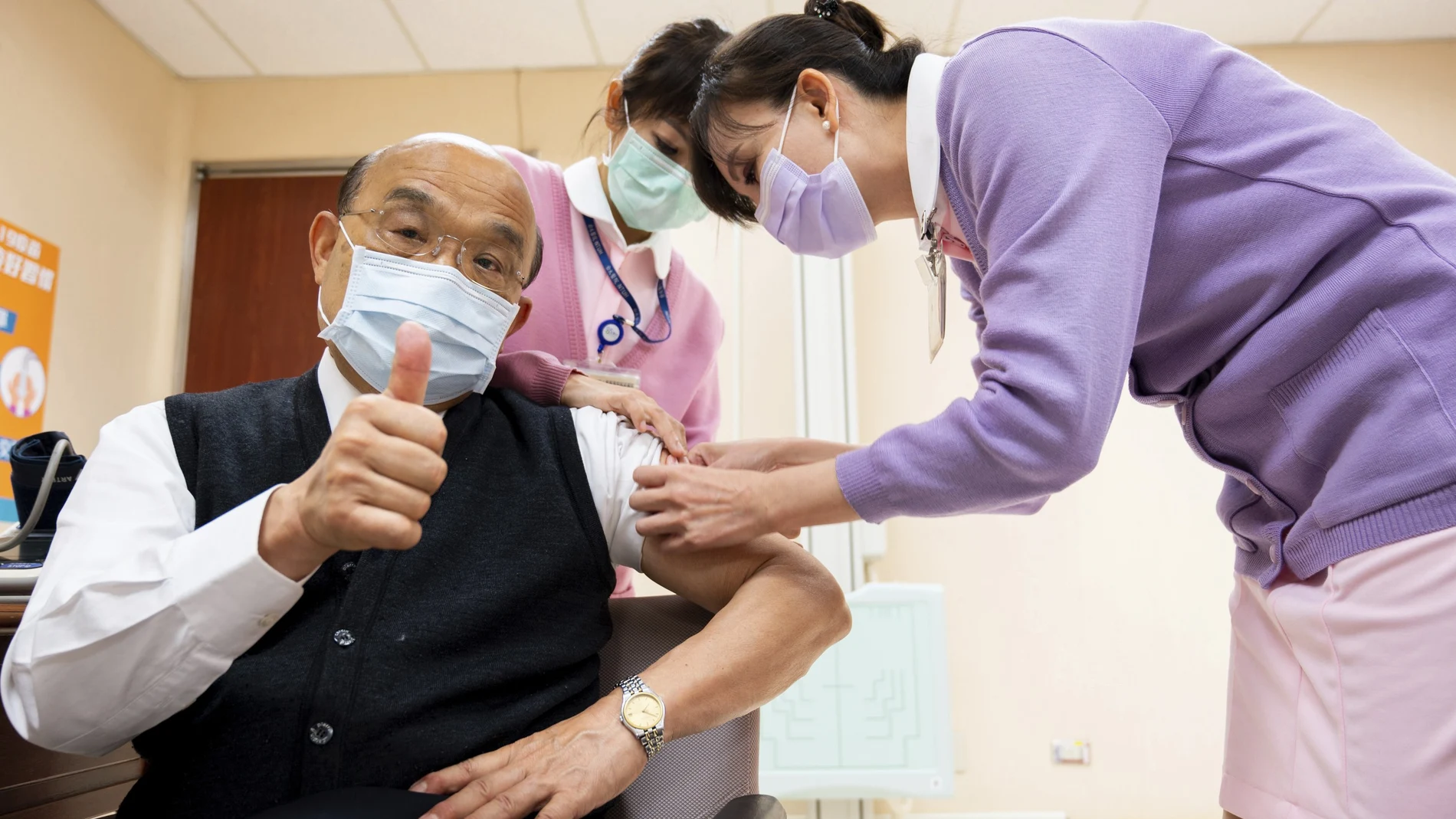 In this photo released by Executive Yuan, Taiwan's Premier Su Tseng-chang thumbs up after receiving a shot of the AstraZeneca vaccine at National Taiwan University Hospital in Taipei, Taiwan, Monday, March 22, 2021. Health care workers received the first shots in Taiwan's COVID-19 vaccination drive Monday, beginning a campaign that won't use supplies from China amid uneven distribution of the vaccines globally. (Executive Yuan via AP)