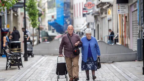 Una pareja camina sin mascarilla por las calles de Gibraltar este domingo