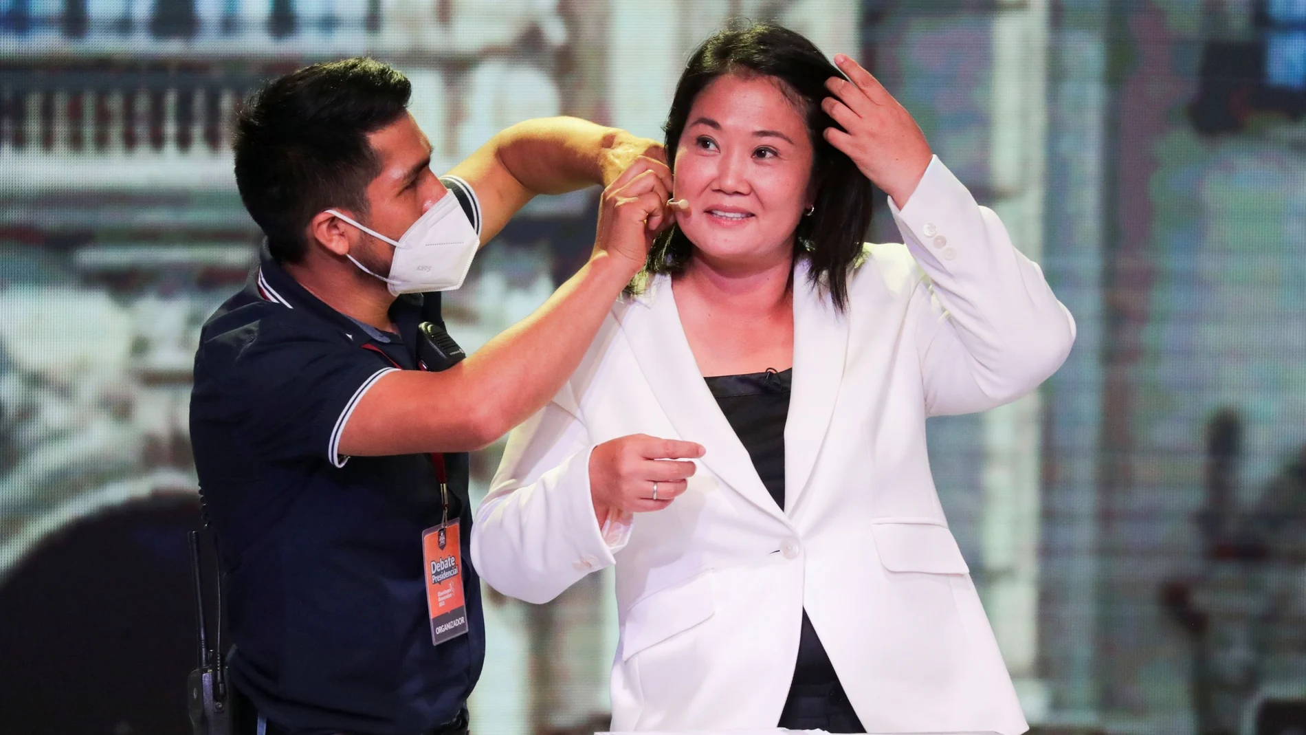 Peru's presidential candidate Keiko Fujimori of the Fuerza Popular party has her microphone adjusted as she prepares to participate in a presidential candidates debate, in Lima, Peru March 29, 2021. REUTERS/Sebastian Castaneda/Pool