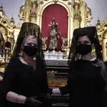 Dos mujeres de mantilla posan frente al Gran Poder de Sevilla