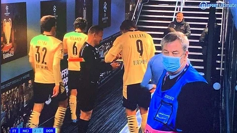 Erling Haaland firma un autógrafo al árbitro asistente rumano Octavian Sovre.