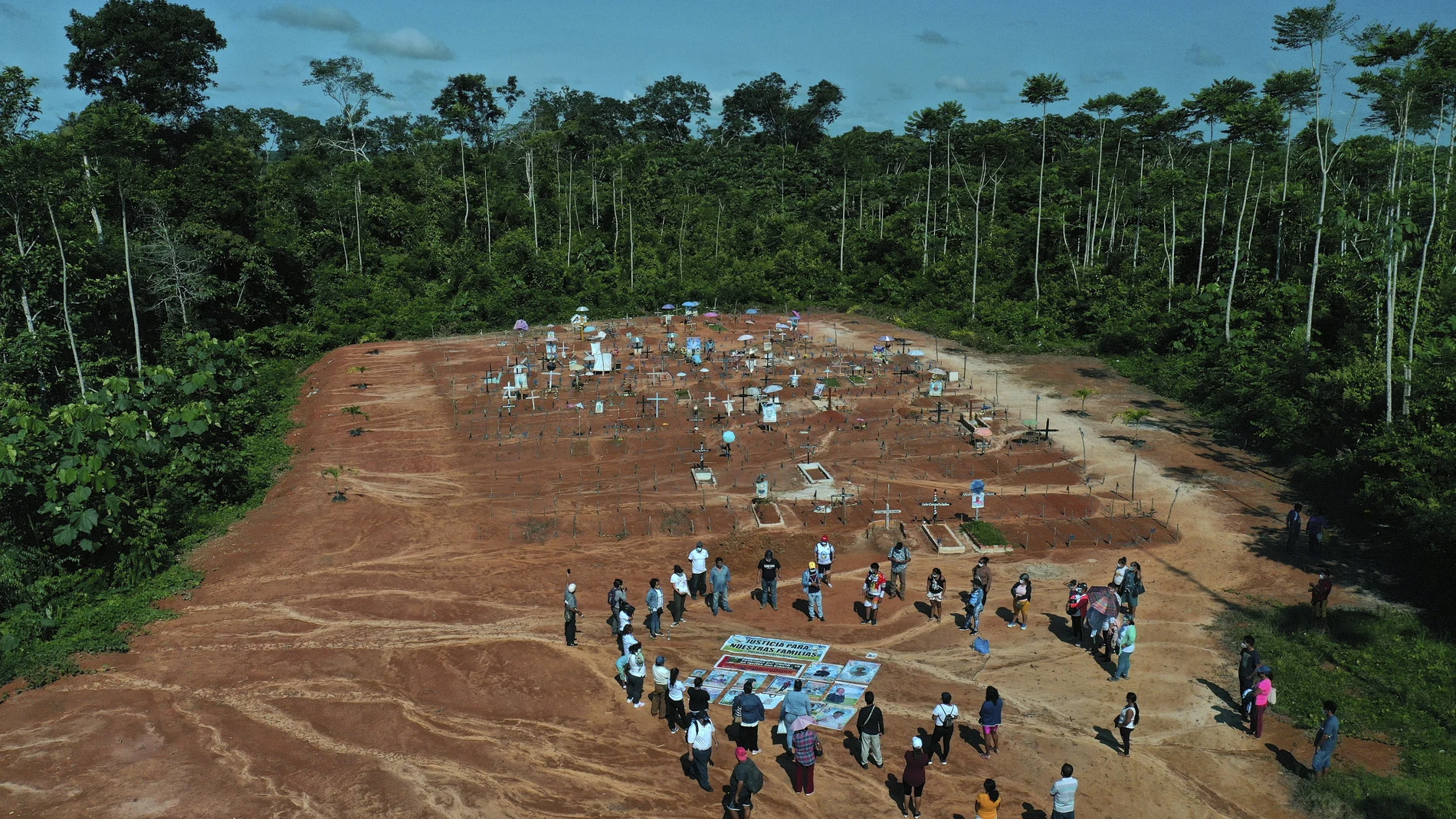 Relatives of people who died from COVID-19 gather next to a clandestine mass grave on the outskirts of Iquitos, Peru, Saturday, March 20, 2021. Local authorities approved the mass burials but never told the families, who believed their loved ones were interred in the nearby local cemetery â€” and only months later discovered the truth.Â (AP Photo/Rodrigo Abd)