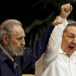 FILE - In this April 19, 2011 file photo, Fidel Castro, left, raises the hand of his brother President Raul Castro as they sing the international socialism anthem during the 6th Communist Party Congress in Havana, Cuba. For most of his life, Raul Castro played second-string to his brother, but for the past decade, itâ€™s Raul who's been the face of communist Cuba. On Friday, April 16, 2021, Raul Castro formally announced he'd step down as head of the Communist Party, leaving Cuba without a Castro in an official position of command for the first time in more than six decades. (AP Photo/Javier Galeano, File)
