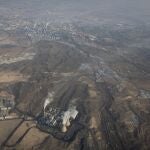 Smoke and steam rise from towers at the coal-fired Urumqi Thermal Power Plant in Urumqi in western China's Xinjiang Uyghur Autonomous Region, Wednesday, April 21, 2021. China, the world's biggest coal user, said Tuesday the fossil fuel will play a less dominant role in its energy mix and that, despite plans to build new coal-fired power plants, the country won't use it on a wide scale. (AP Photo/Mark Schiefelbein)