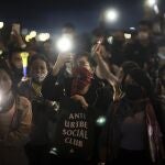 Protesters attend an anti-government march at an intersection in Bogota, Colombia, Wednesday night, May 12, 2021. Colombians have taken to the streets for weeks across the country, after the government proposed tax increases on public services, fuel, wages and pensions, but have continued even after President Ivan Duque walked back the tax hike. (AP Photo/Ivan Valencia)