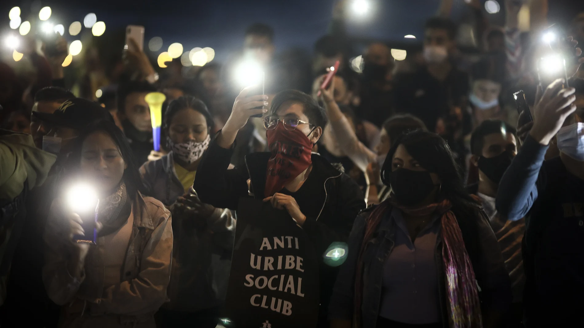 Protesters attend an anti-government march at an intersection in Bogota, Colombia, Wednesday night, May 12, 2021. Colombians have taken to the streets for weeks across the country, after the government proposed tax increases on public services, fuel, wages and pensions, but have continued even after President Ivan Duque walked back the tax hike. (AP Photo/Ivan Valencia)