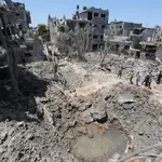 Un grupo de gazatíes comprueba los daños tras los bombardeos al norte de la Franja