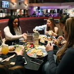 Británicos disfrutan de una comida dentro de un pub en Reino Unido