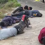 Un grupo de inmigrantes descansa tras su llegada este martes a uno de los espigones fronterizos de Ceuta