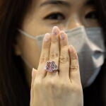 Hong Kong (China), 20/05/2021.- A woman displays the Sakura Diamond during preview at Christie's in Hong Kong, China, 20 May 2021. The 15.81 Carat Fancy Vivid Purple Pink Internally Flawless Type lla Diamond Ring will be auctioned in Hong Kong on 23 May 2021 for an estimated 25 million to 38 million US dollars. EFE/EPA/JEROME FAVRE