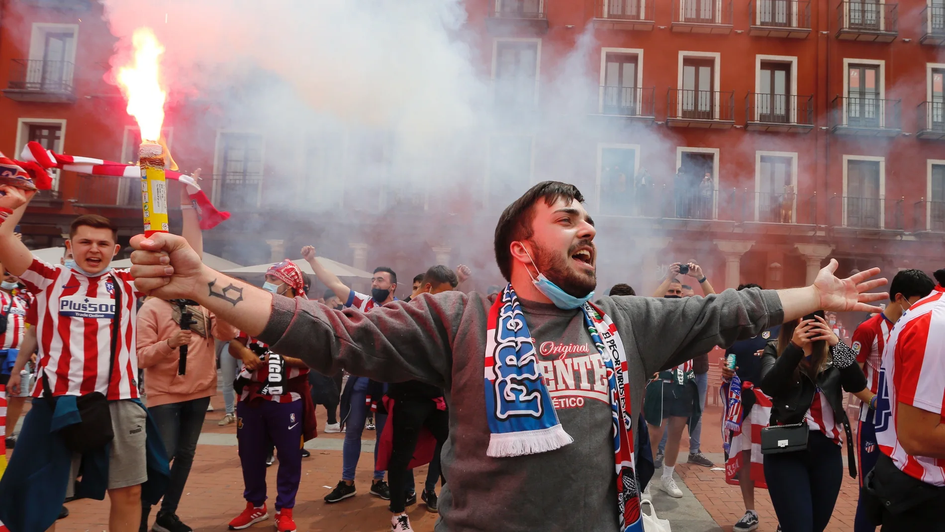 Un aficionado del Atlético sujeta una bengala en las calles de Valladolid.