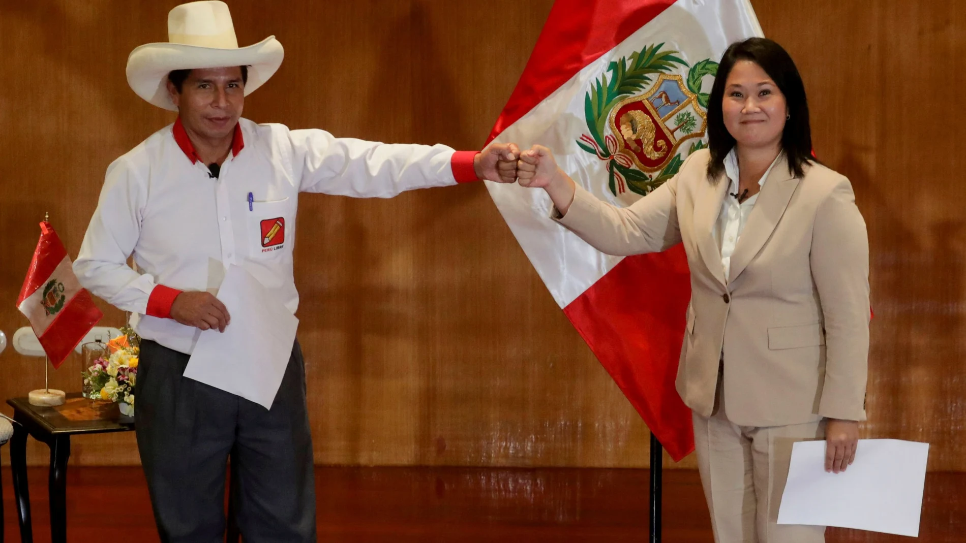 FILE PHOTO: Peruvian presidential candidates Pedro Castillo and Keiko Fujimori, who will face each other in a run-off vote on June 6, gesture after signing a "Pact for Democracy," in Lima, Peru May 17, 2021. REUTERS/Sebastian Castaneda/File Photo