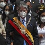 Ecuador's new President Guillermo Lasso wears the presidential sash after his inauguration ceremony as he exits the National Assembly with his wife Maria de Lourdes, partially covered left, and daughter Maria Mercedes, second from left, in Quito, Ecuador, Monday, May 24, 2021. At right is National Assembly President Guadalupe Llora. (AP Photo/Dolores Ochoa)