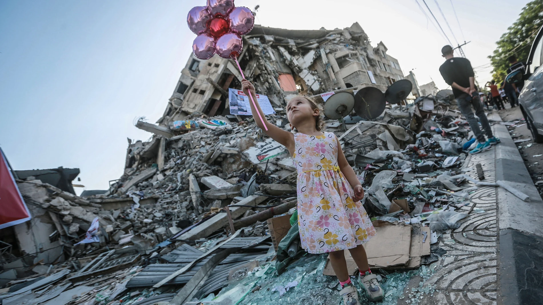 Una niña coge unos globos en medios de los escombros provocados durante los once días de ofensiva militar en Gaza