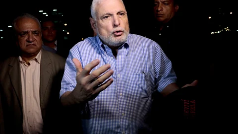 FILE - In this Aug. 9, 2019 file photo, Panama's former President Ricardo Martinelli talks to reporters near his home, in Panama City. Martinelli and former President Juan Carlos Varela are on the list of 50 people that an anti-corruption prosecutor's office asks to be called to trial in the bribery case of involving the Brazilian construction company Odebrecht, said prosecutor Tania Sterling, on Wednesday, May 26, 2021. (AP Photo/Eric Batista, File)