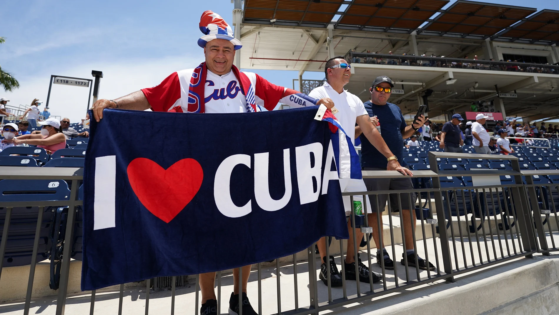 May 31, 2021; West Palm Beach, Florida, USA; A fan of the Cuban team holds a flag during the WBSC Baseball Americas Qualifier series of baseball games between Cuba and Venezuela at The Ballpark of the Palm Beaches. Mandatory Credit: Jasen Vinlove-USA TODAY Sports