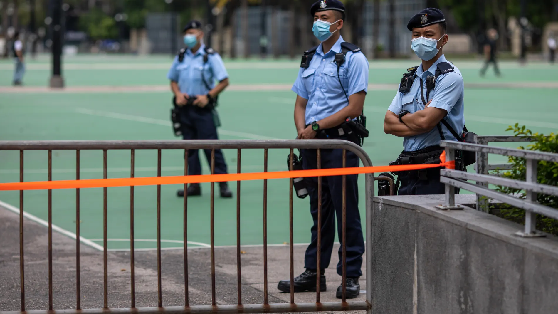 Hong Kong (China), 04/06/2021.- Police stand guard in a sealed-off Victoria Park in Hong Kong, China, 04 June 2021. Police sealed-off most parts of the park, saying they had seen online appeals for people to gather there despite a ban to commemorate in public the 1989 Tiananmen Square crackdown that took place in Beijing. It is the second year in a row police banned the annual candlelight vigil in Victoria Park citing ongoing public health threat posed by the COVID-19 pandemic. EFE/EPA/JEROME FAVRE