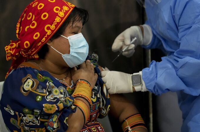 A healthcare worker gives a Guna Indigenous woman a shot of the AstraZeneca vaccine for COVID-19 at the Mega Mall on the outskirts of Panama City, Wednesday, June 9, 2021. On Wednesday, Panama began vaccinating women age 30 and older. (AP Photo/Arnulfo Franco)