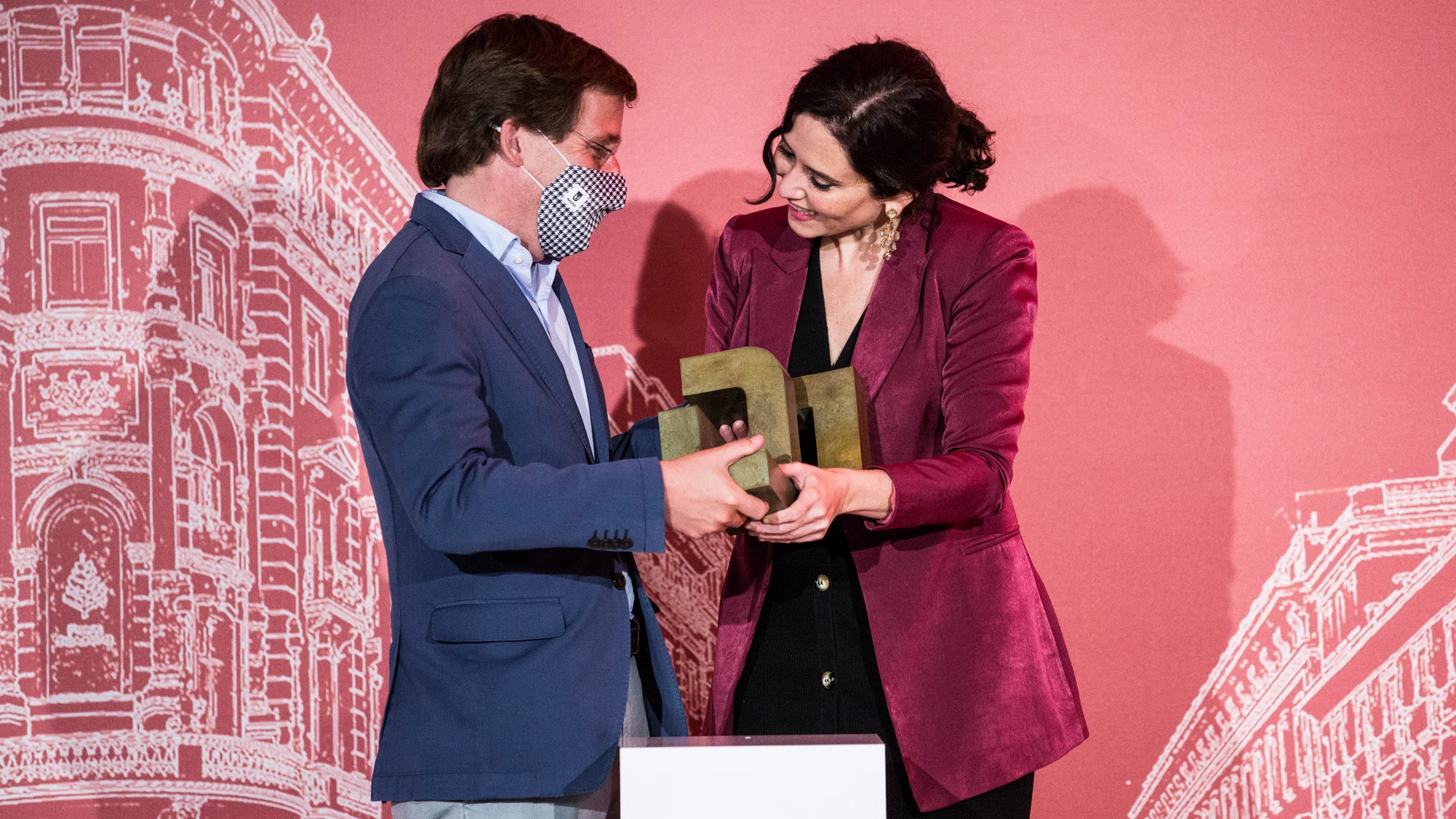 La presidenta de la Comunidad de Madrid en funciones, Isabel Díaz Ayuso, recibe uno de los premios en la XVIII edición de los Premios Madrid, de la mano del alcalde de Madrid, José Luis Martínez-Almeida.
