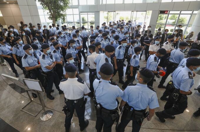 Police gather in the lobby of the Apple Daily headquarters in Hong Kong, Thursday, June 17, 2021. Hong Kong police on Thursday morning arrested the chief editor and four other senior executives of Apple Daily under the national security law on suspicion of collusion with a foreign country to endanger national security, according to local media reports. (Apple Daily via AP)