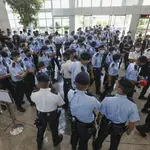 Police gather in the lobby of the Apple Daily headquarters in Hong Kong, Thursday, June 17, 2021. Hong Kong police on Thursday morning arrested the chief editor and four other senior executives of Apple Daily under the national security law on suspicion of collusion with a foreign country to endanger national security, according to local media reports. (Apple Daily via AP)