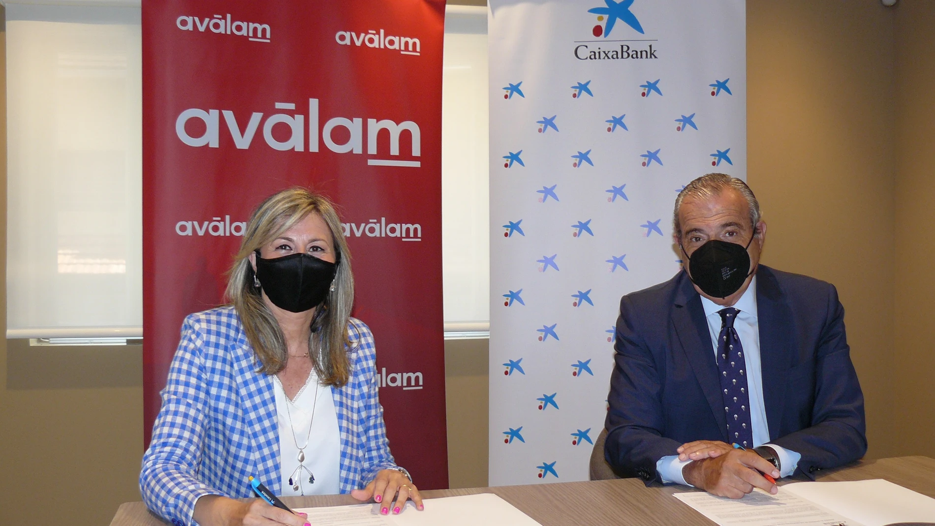 La directora de Territorial de CaixaBank en Murcia, Olga García; y el director general de Avàlam, Luis Martínez de Salas, firman el convenio