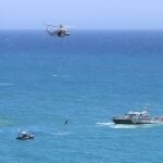 Un miembro de Salvamento Marítimo baja con una cuerda del helicóptero para trasladar el cuerpo sin vida de la mujer que ayer desapareció junto a otro bañista en Cala Rajá