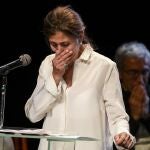 Former Colombian presidential candidate Ingrid Betancourt, who was abducted while campaigning by the Revolutionary Armed Forces of Colombia, FARC, rebels, cries as she stands on the rostrum during an event at the Truth Commission to commemorate victims of the countryâ€™s decades-long armed conflict, in Bogota, Colombia, Wednesday, June 23, 2021. (AP Photo/Ivan Valencia)