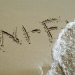 Wi-Fi escrito en la arena que indica Internet sin hilos en la playa.