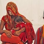 Women wait to receive the vaccine for COVID-19 in New Delhi, India, Friday, July 2, 2021. India crosses a grim mark of 400,000 people lost to the coronavirus, half of them in the past two months during which the virulent delta variant was detected in the country. India, a country of nearly 1.4 billion people, is the third to cross 400,000 deaths, behind the United States and Brazil. (AP Photo/Manish Swarup)