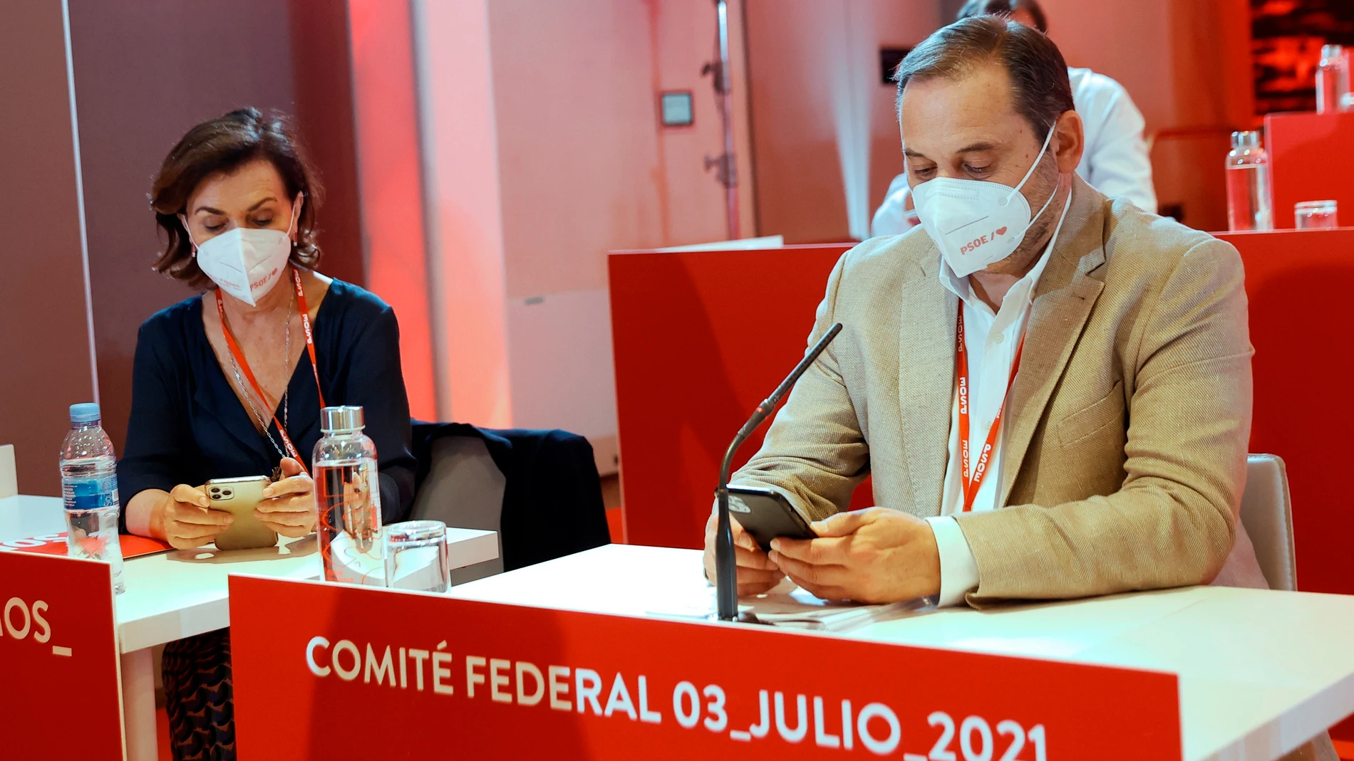 La ex vicepresidenta del Gobierno, Carmen Calvo, y el exministro de Transportes, José Luis Ábalos, revisan sus teléfonos mientras, participan en la reunión del Comité Federal del PSOE