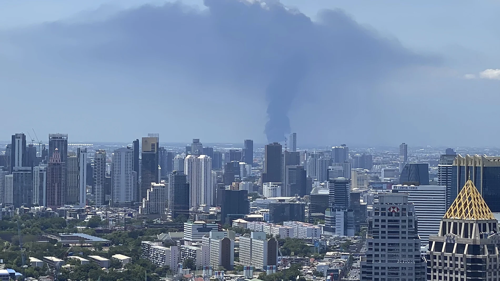 In a view from downtown Bangkok, giant plumes of smoke can be seen rising from the Samut Prakan province, Thailand, Monday, July 5, 2021. A massive explosion at a factory on the outskirts of Bangkok has shaken an airport terminal serving Thailandâ€™s capital, damaged homes in the surrounding neighborhood, and prompted the evacuation of a wide area over fears of poisonous fumes from burning chemicals and the possibility of additional denotations. (Tina Liu via AP)