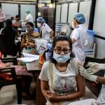 Una joven reacciona al recibir la vacuna contra el coronavirus en el Hospital Shatabdi en Bombay, India