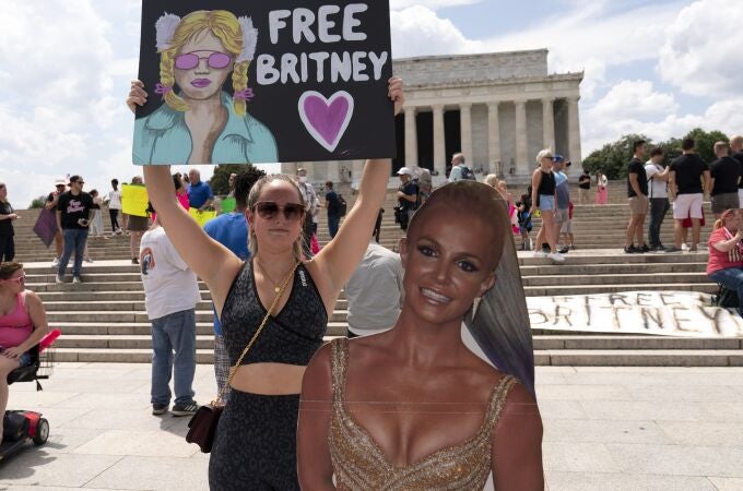 Maggie Howell supporter of pop star Britney Spears protests next to a Britney Spears cardboard cutout at the Lincoln Memorial, during the "Free Britney" rally, Wednesdays, July 14, 2021, in Washington. Rallies have been taking place across the country since the pop star spoke out against her conservatorship in court last month. (AP Photo/Jose Luis Magana)