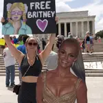 Maggie Howell supporter of pop star Britney Spears protests next to a Britney Spears cardboard cutout at the Lincoln Memorial, during the &quot;Free Britney&quot; rally, Wednesdays, July 14, 2021, in Washington. Rallies have been taking place across the country since the pop star spoke out against her conservatorship in court last month. (AP Photo/Jose Luis Magana)