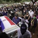 Pallbearers carry the coffin that contain the remains of Leidy Vanessa Luna Villalba outside her home, in Eugenio Garay, Paraguay, Tuesday, July 13, 2021. Luna Villalba, a nanny employed by the sister of Paraguay's first lady Silvana Lopez Moreira, was among those who died in the Champlain Towers South condominium collapse in Surfside, Florida on June 24. (AP Photo/Jorge Saenz)