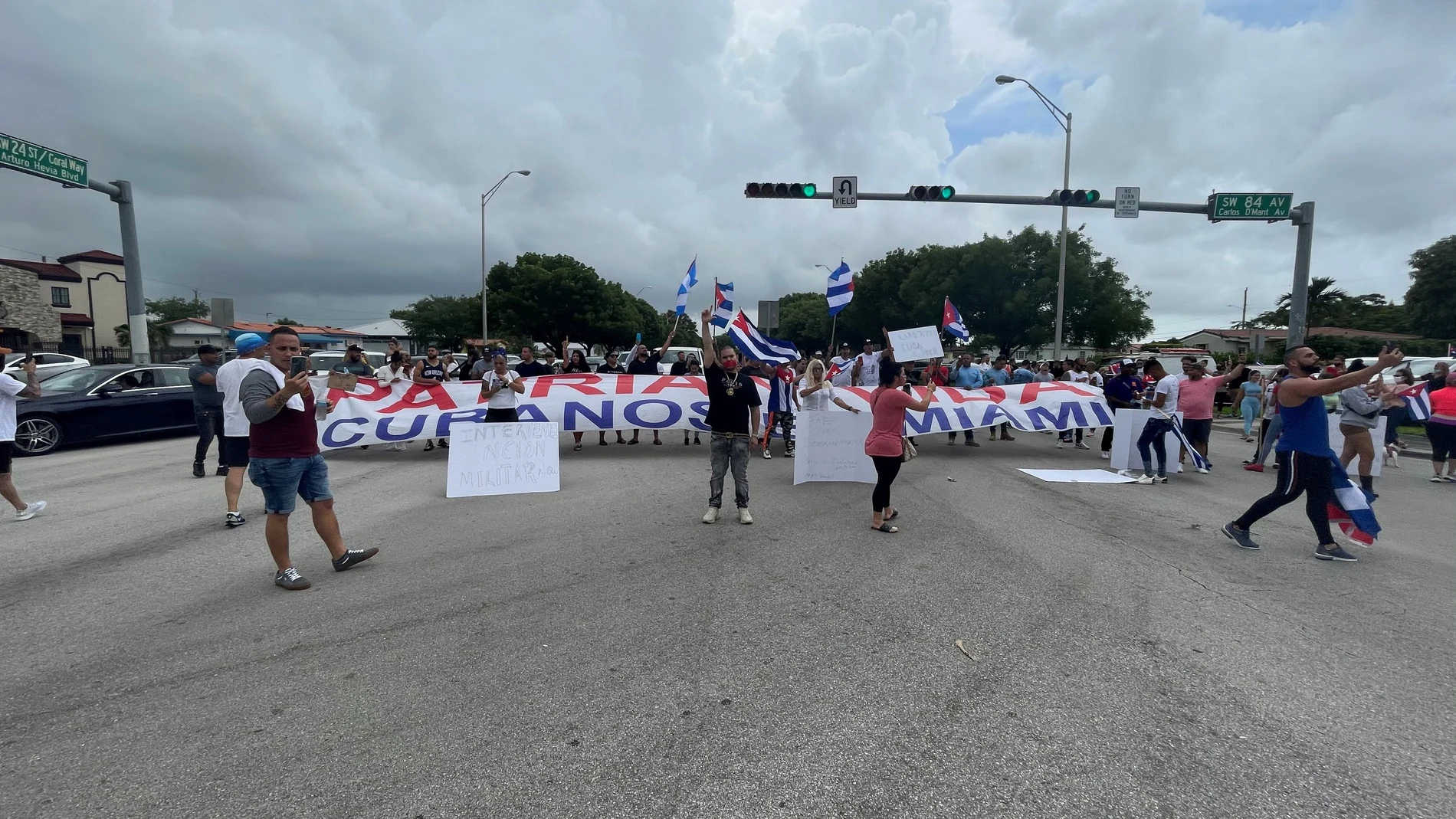 People hold flags, signs and a banner on the Palmetto Expressway following reports of protests in Cuba against its deteriorating economy, in Miami, Florida, July 13, 2021, in this image obtained via social media. INSTAGRAM @STANDFORCUBA via REUTERS ATTENTION EDITORS - THIS IMAGE HAS BEEN SUPPLIED BY A THIRD PARTY. MANDATORY CREDIT. NO RESALES. NO ARCHIVES.