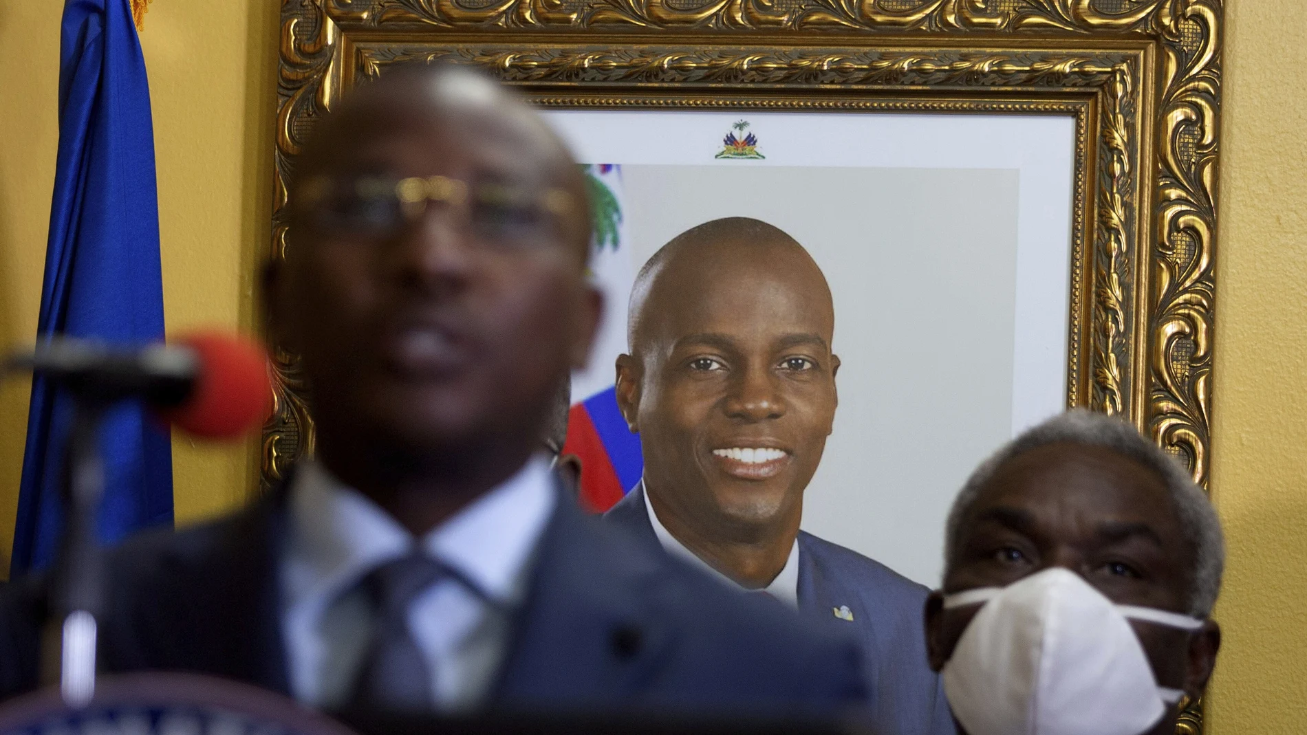 A picture of late Haitian President Jovenel Moise hangs on the wall of his former residence, behind interim Prime Minister Claude Joseph giving a press conference in Port-au-Prince, Tuesday, July 13, 2021. Authorities in Haiti on Thursday forcefully pushed back against reports that current government officials were involved in the July 7 killing of Haitian President Jovenel MoÃ¯se, calling them â€œa lie.â€ (AP Photo/Joseph Odelyn)