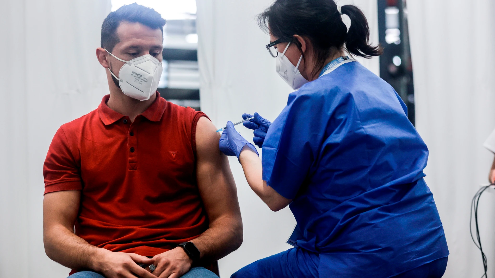 El joven de 31 años Oscar Parra, recibió estatarde de la sanitaria Mercè Costa la vacuna número 500.000 en el centro de vacunación masivo de la Fira de Barcelona.