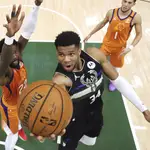 Milwaukee Bucks&#39; Giannis Antetokounmpo shoots next to Phoenix Suns&#39; Deandre Ayton, left, during the second half of Game 6 of basketball&#39;s NBA Finals, Tuesday, July 20, 2021, in Milwaukee. (Justin Casterline/Pool Photo via AP)
