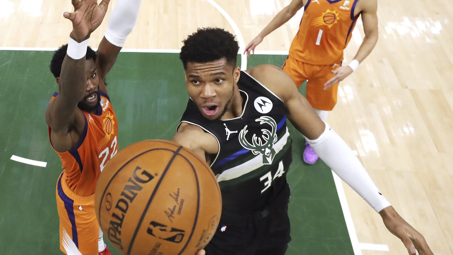 Milwaukee Bucks' Giannis Antetokounmpo shoots next to Phoenix Suns' Deandre Ayton, left, during the second half of Game 6 of basketball's NBA Finals, Tuesday, July 20, 2021, in Milwaukee. (Justin Casterline/Pool Photo via AP)