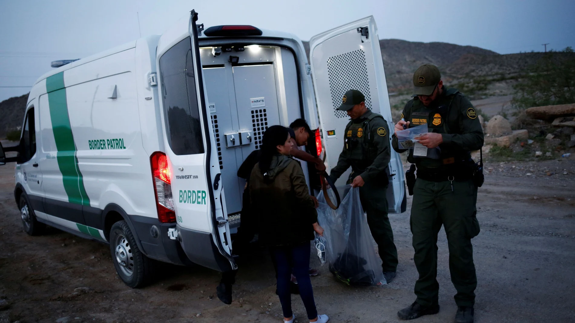 FILE PHOTO: Migrants from Central America who were detained hand over their belongings to U.S. Border Patrol agents after crossing into the United States from Mexico, in Sunland Park, New Mexico, U.S., July 22, 2021. REUTERS/Jose Luis Gonzalez/File Photo