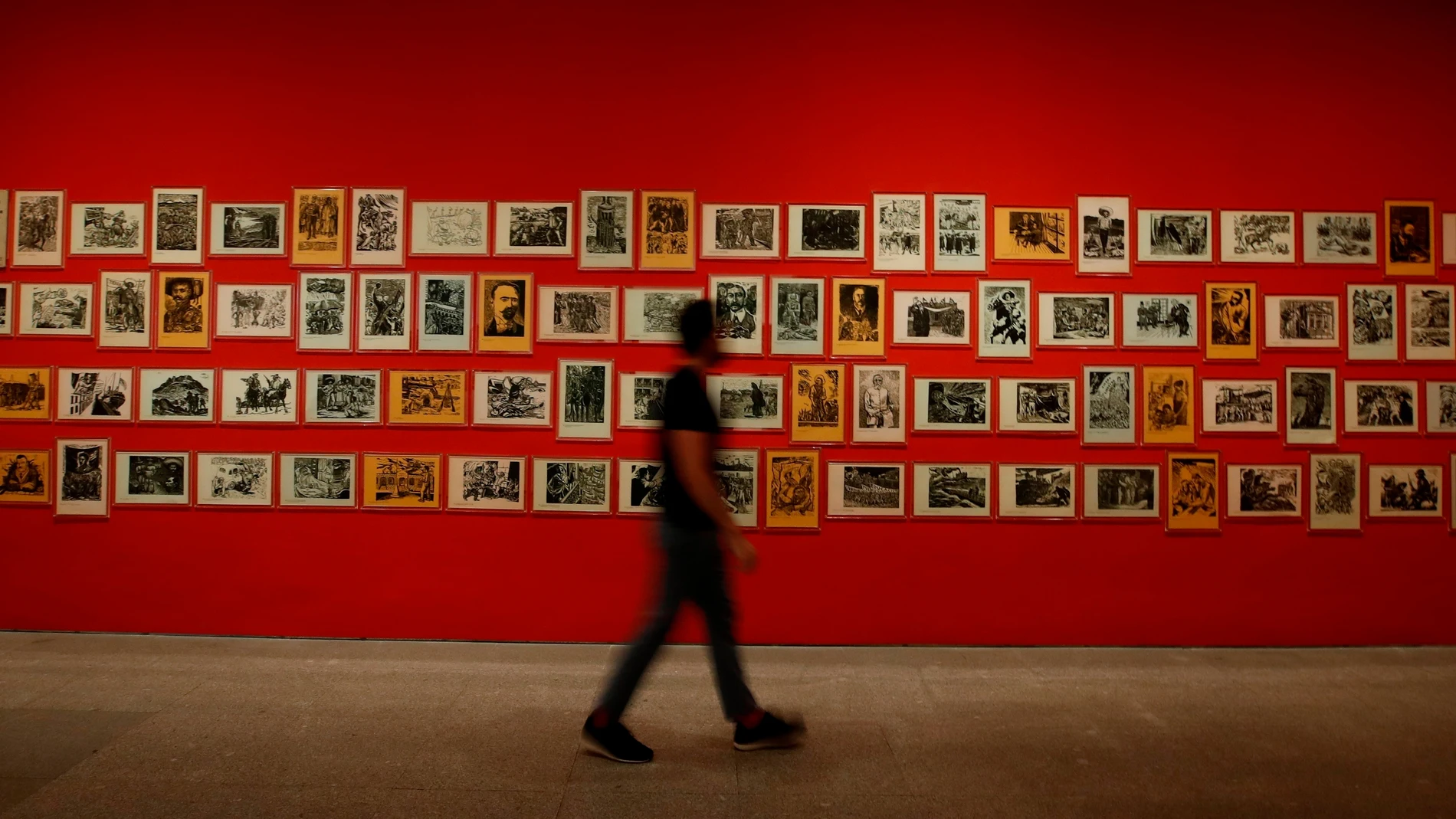 Un visitante pasa delante de la obra "Estampas de la Revolución mexicana" (1947), una serie de linograbados sobre papel