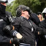 Agentes de Policía detienen a un manifestante durante una protesta contra las medidas contra el coronavirus en Berlín