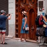 Dos turistas se fotografía en una calle del centro histórico de València, este domingo